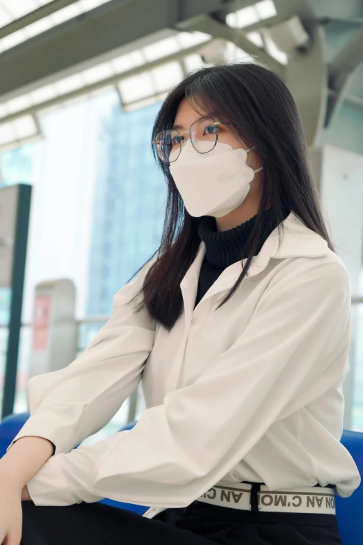 a woman wearing a face mask sitting on a bench, inspired by Feng Zhu, happening, wearing lab coat and a blouse, airport, ivory, skimask