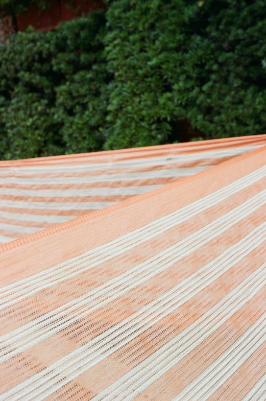 a man laying in a hammock on top of a roof, orange racing stripes, ivory and copper, detail shot, canopies