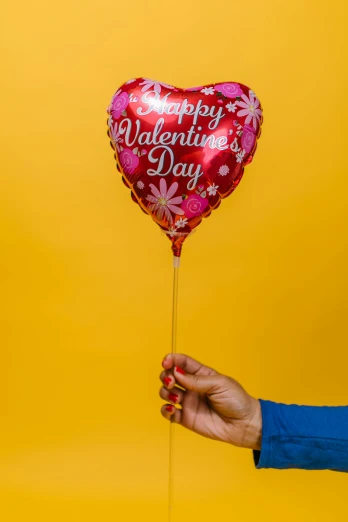 a person holding a heart shaped balloon that says happy valentine's day, official product photo, flower power, f / 2 0, foil