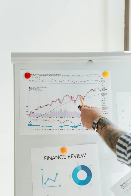 a man pointing to a white board with graphs on it, by Adam Marczyński, trending on unsplash, medium shot taken from behind, 🚀🌈🤩, product view, liam brazier