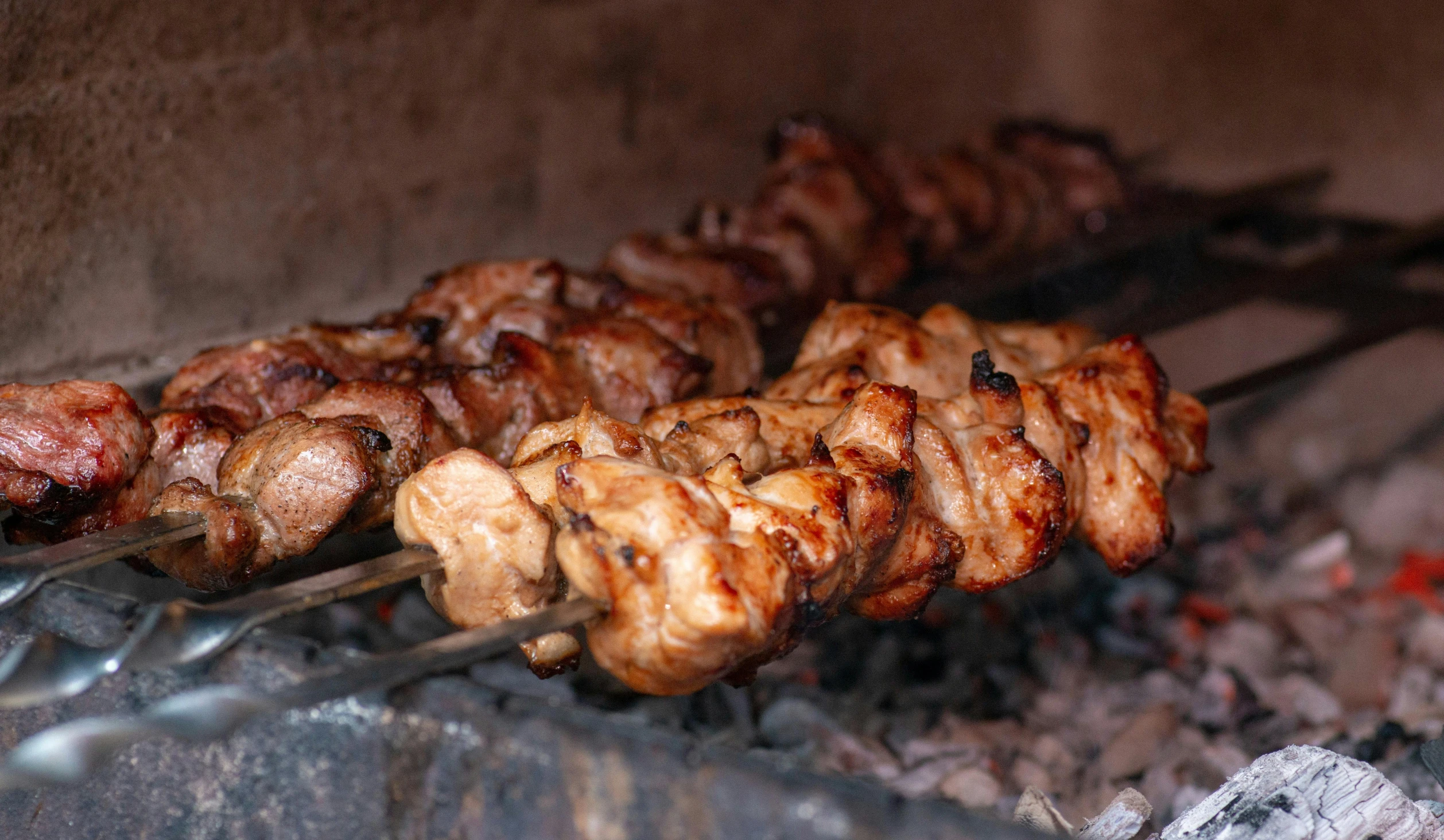 a close up of meat on skewers on a grill, by Niko Henrichon, pexels contest winner, hurufiyya, woodfired, profile image, middle eastern, chicken