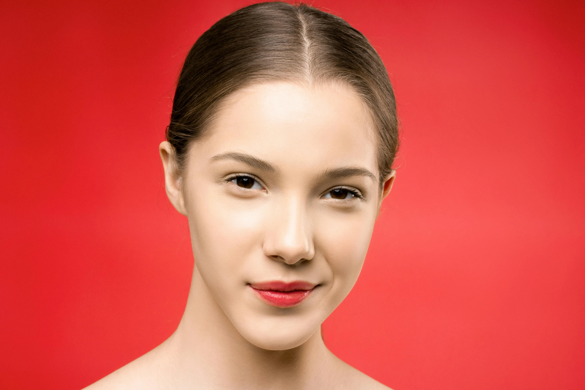 a beautiful young woman posing in front of a red background, by Julia Pishtar, shutterstock contest winner, clean perfect symmetrical face, natural soft pale skin, professional closeup photo, photo realistic image