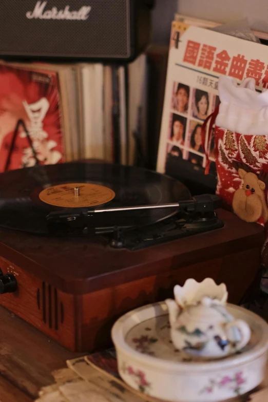 a record player sitting on top of a wooden table, an album cover, inspired by Ernest William Christmas, pexels, home video footage, mid view, festive atmosphere, slide show