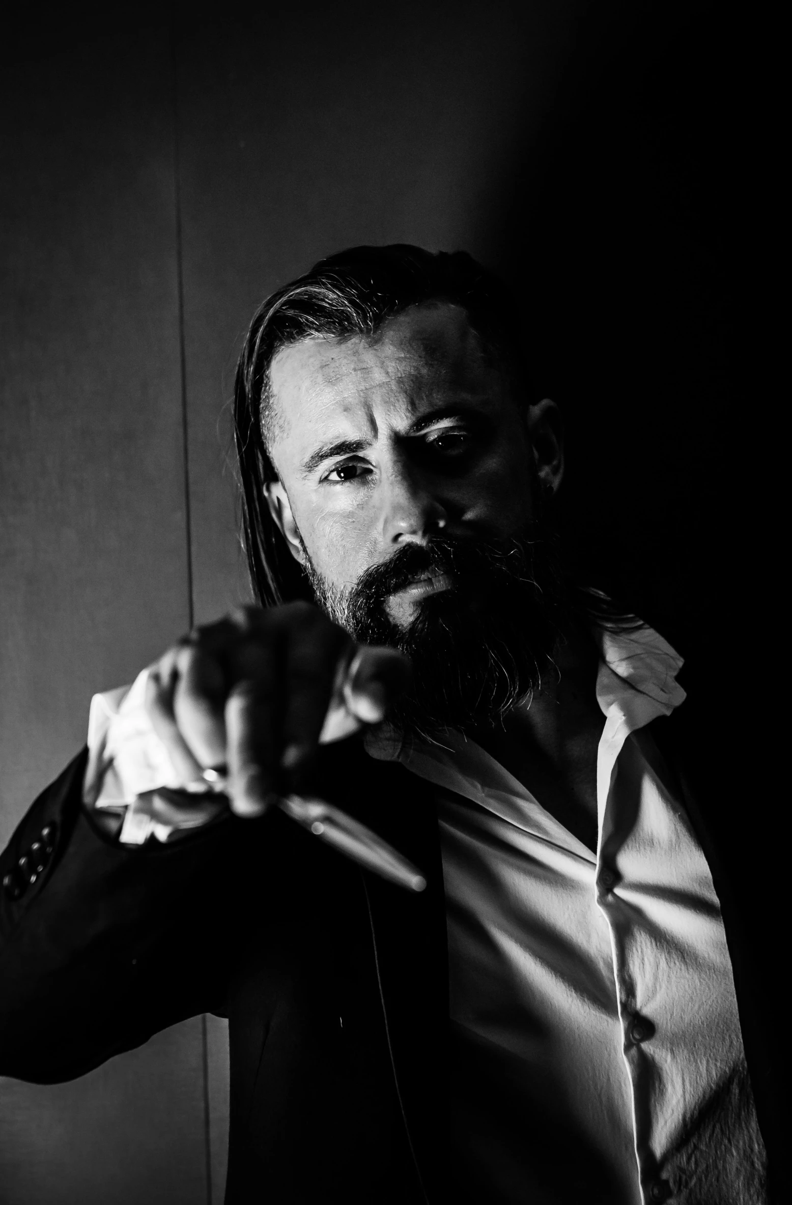 a black and white photo of a man with a beard, by Giuseppe Avanzi, till lindemann, katana in hand, john wick, square