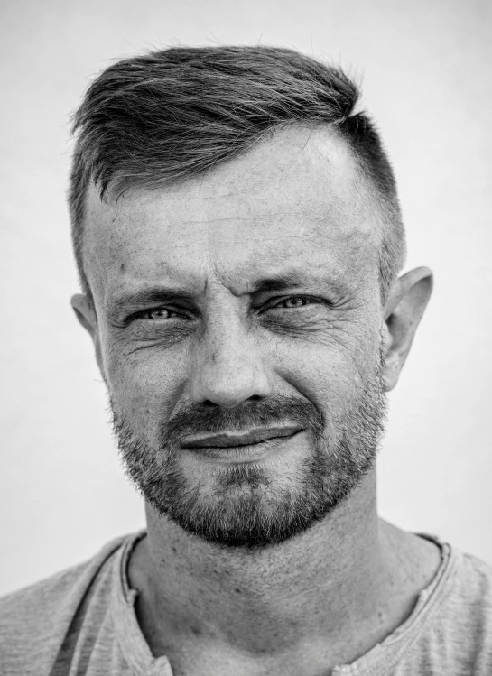 a black and white photo of a man with a beard, inspired by Adam Pijnacker, african aaron paul, headshot profile picture, graham humphreys, photograph taken in 2 0 2 0