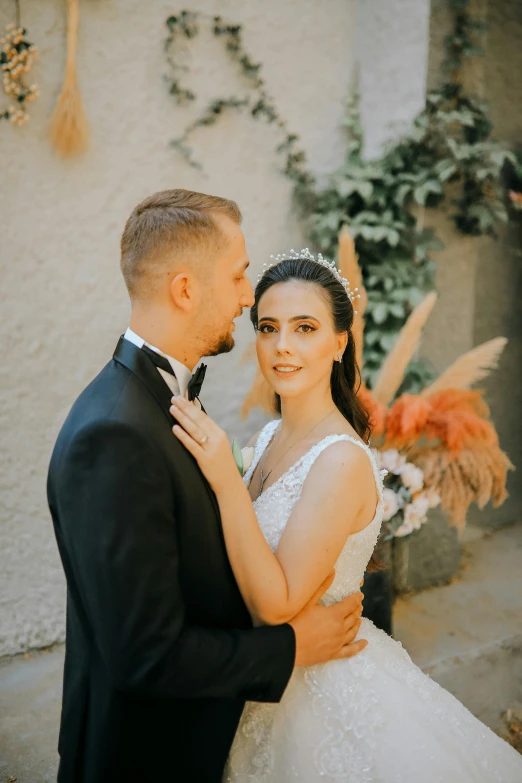 a bride and groom standing next to each other, a colorized photo, pexels contest winner, romanticism, profile image, dasha taran, lovingly looking at camera, thumbnail