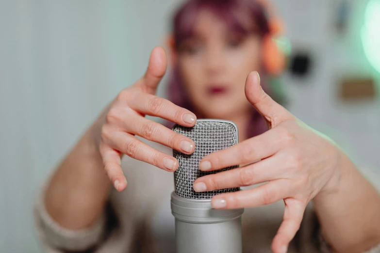 a woman holding a microphone in front of her face, trending on pexels, avatar image, realistic »