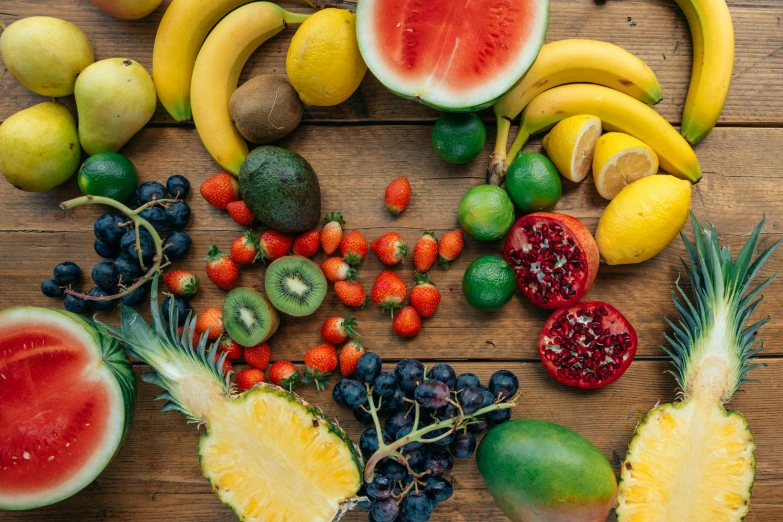 a bunch of fruit sitting on top of a wooden table, by Niko Henrichon, unsplash, avatar image, background image, full frame image, multicoloured