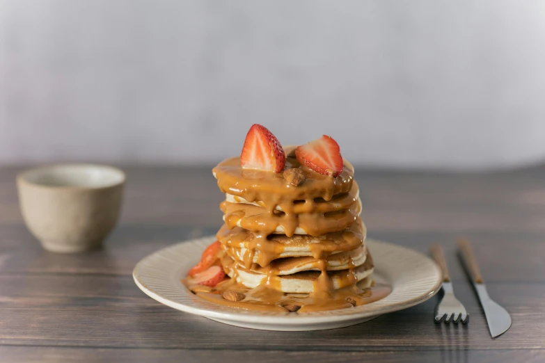 a stack of pancakes covered in peanut butter and strawberries, inspired by Richmond Barthé, unsplash, singapore, caramel, profile image