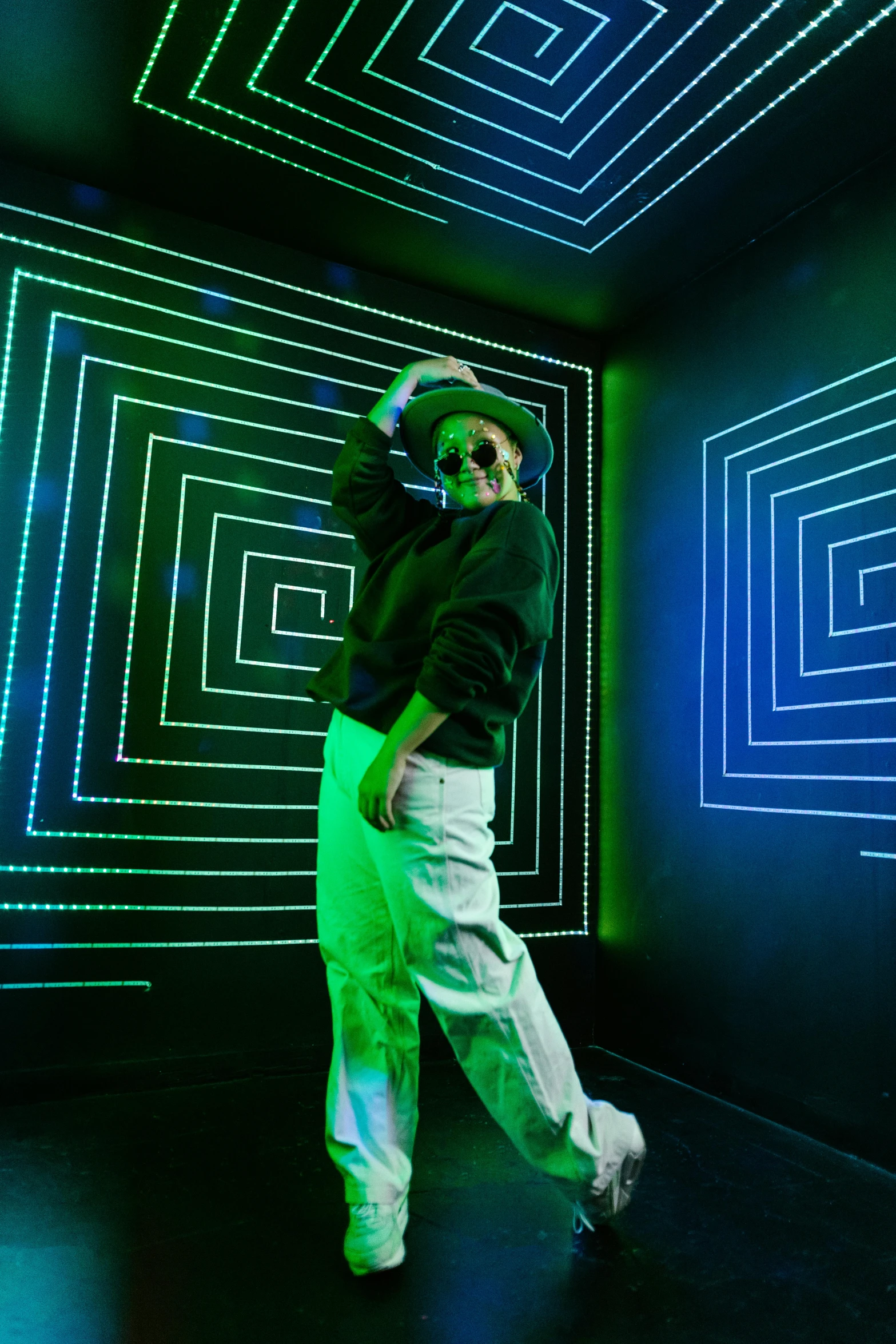 a man standing in front of a wall with neon lights, inspired by Richard Anuszkiewicz, interactive art, doing a sassy pose, green lines, in the magic room, pete davidson