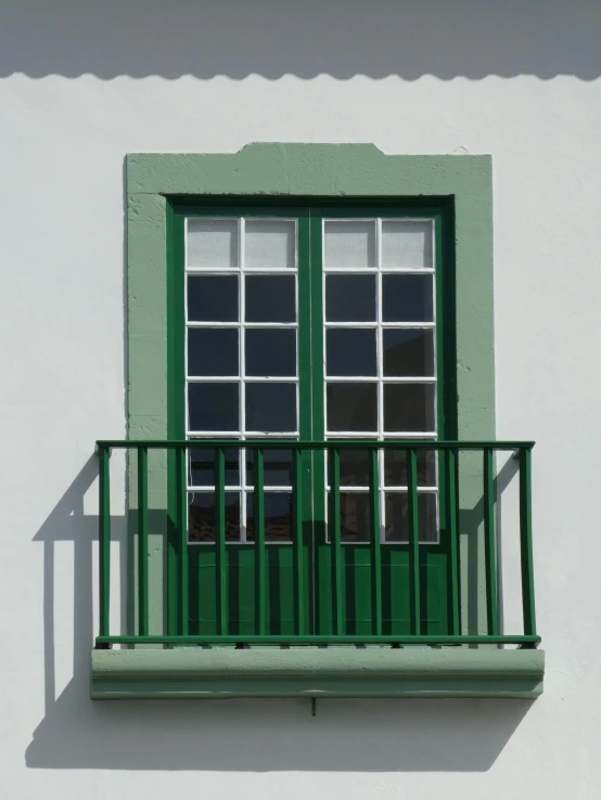 a green window on the side of a white building, farol da barra, leica s photograph, no textures, ( ( railings ) )