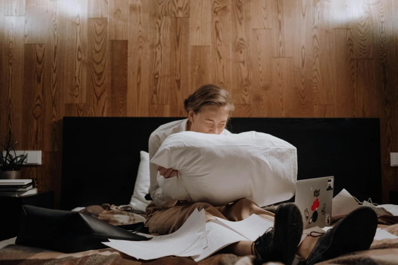 a woman sitting on top of a bed covered in pillows, a drawing, pexels contest winner, happening, with a laptop on his lap, greta thunberg, ignant, high class