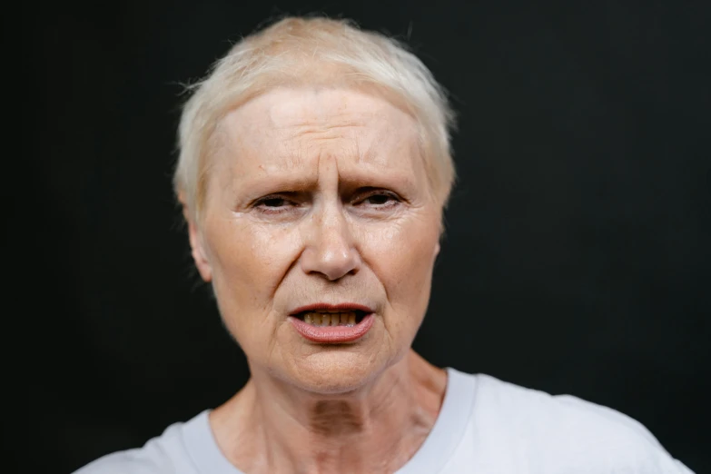 a woman with a surprised look on her face, by David Begbie, pexels contest winner, photorealism, grumpy [ old ], pale woman, strong jaw, non binary model