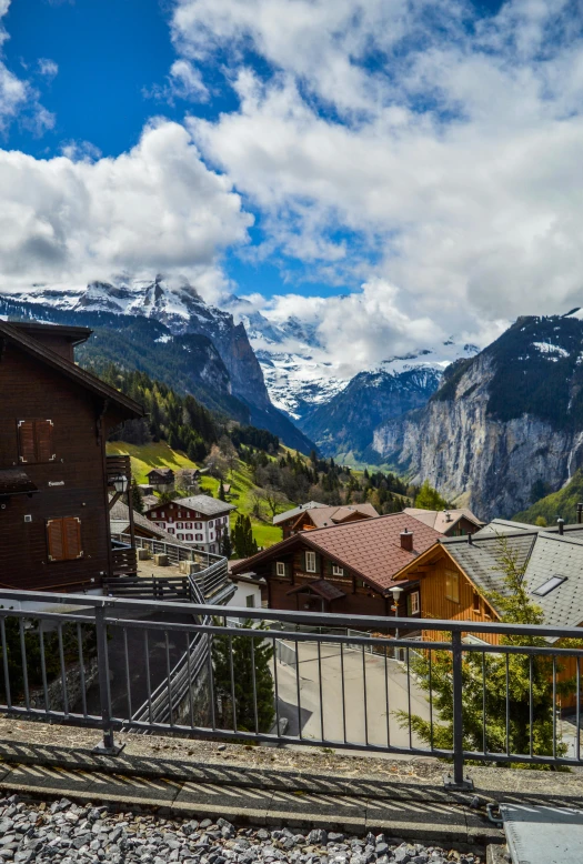 a train traveling down train tracks next to a mountain, inspired by Karl Stauffer-Bern, pexels contest winner, view of villages, balcony, glaciers, staggered terraces