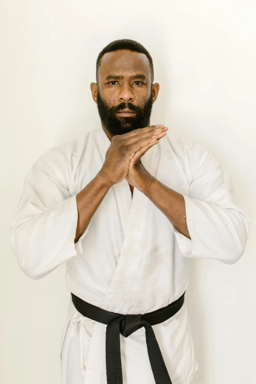 a man in a white shirt and black belt, jamal campbell, man with beard, symmetrical pose, robert kondo