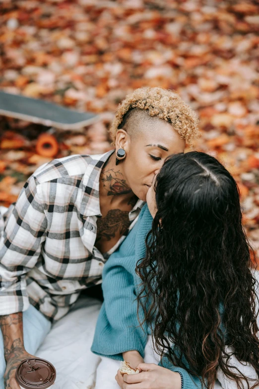 a man and woman sitting on a blanket next to a skateboard, a tattoo, trending on pexels, lesbian kiss, fall foliage, ashteroth, profile pic