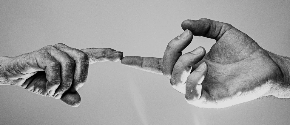 a black and white photo of two hands touching each other, by Alexis Grimou, unsplash, surrealism, holding a thick staff, giving the middle finger, saatchi art, broken down