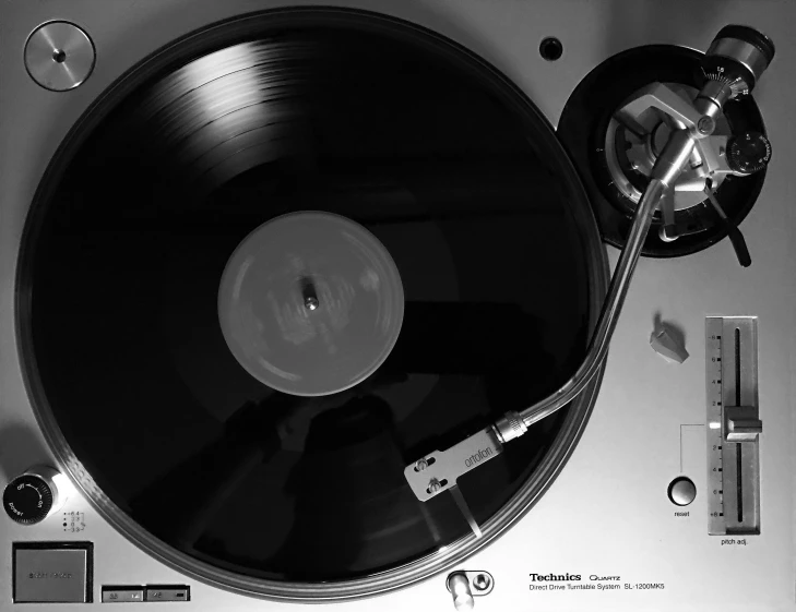 a black and white photo of a turntable, an album cover, by Tony Tuckson, wikimedia commons, sports photo, high details photo, 80s photo