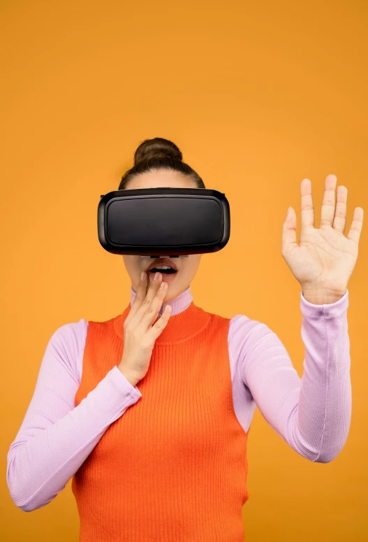 a woman wearing a virtual reality headset, shutterstock, hypermodernism, square, in front of an orange background, gesture, trending on mentalray