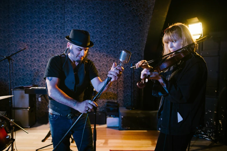 a couple of people standing next to each other on a stage, unsplash, art nouveau, violin, studio recording, blue grass, digging