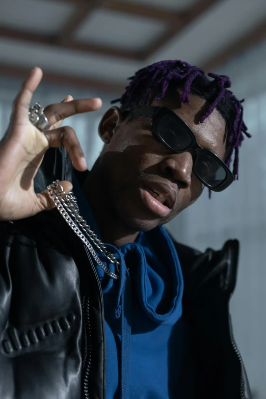 a man with purple dreads talking on a cell phone, an album cover, trending on pexels, gold chains, joseph joestar, wearing shades, black teenage boy
