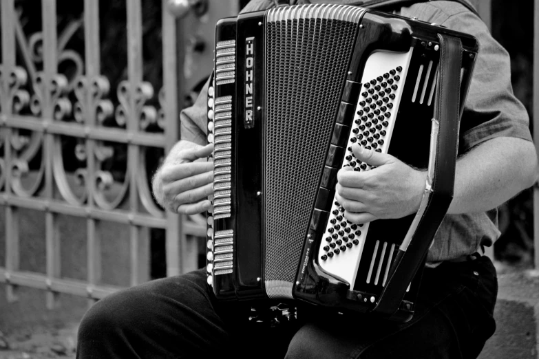 a black and white photo of a man playing an accordion, by Ivana Kobilca, pexels, square, 15081959 21121991 01012000 4k