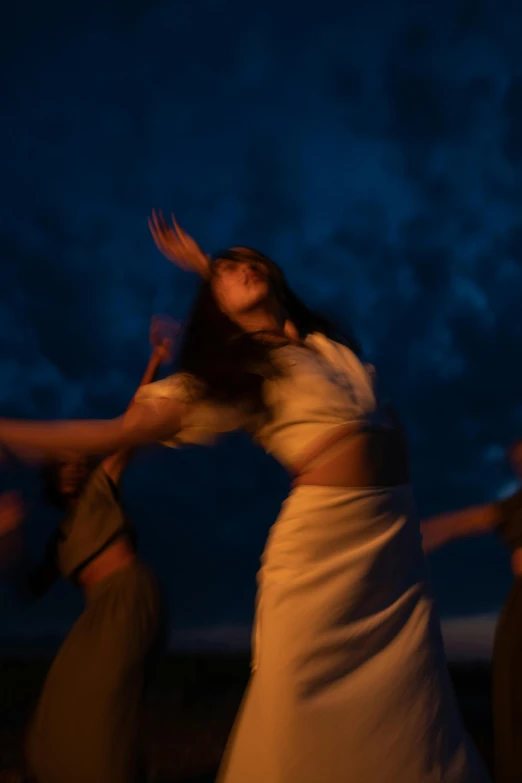 a group of women standing on top of a beach, an album cover, unsplash, figuration libre, theater dance scene, at nighttime, dramatic white and blue lighting, mingchen shen