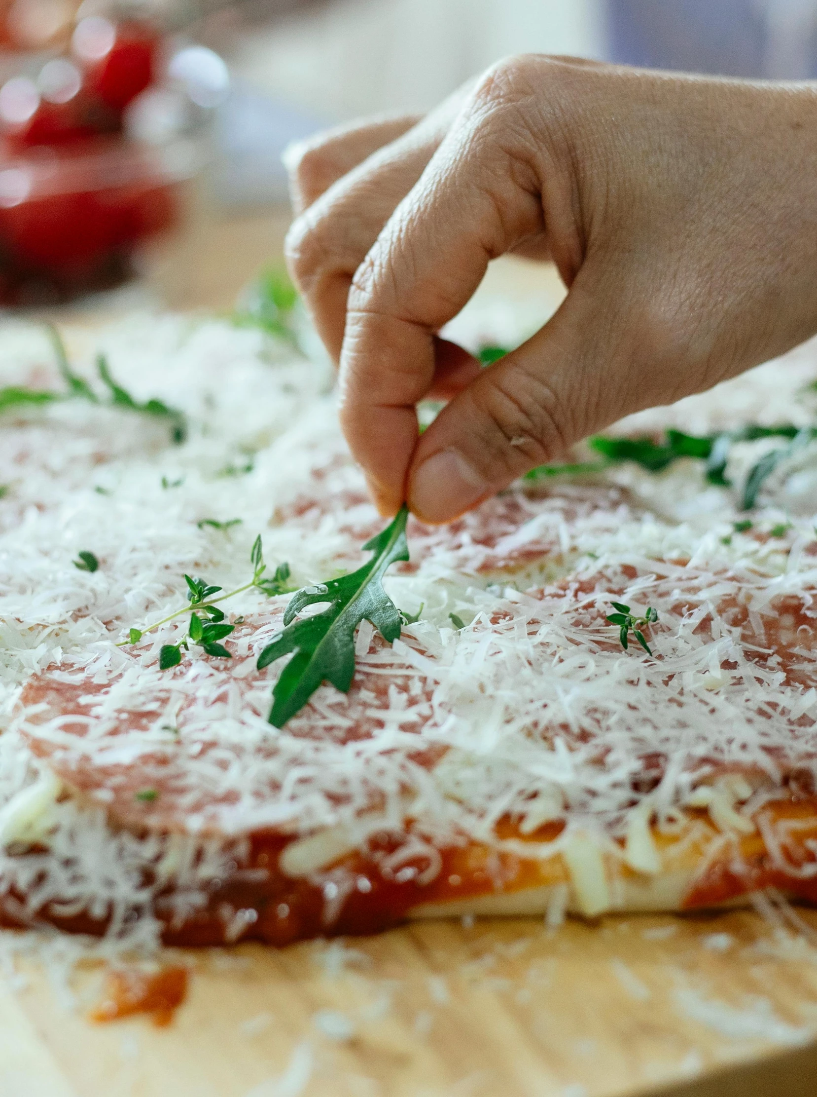 a person putting parmesan cheese on top of a pizza, by Julia Pishtar, twisting organic tendrils, medium close up, promo image