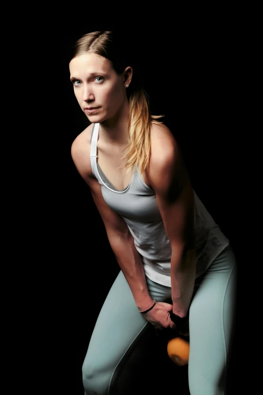 a woman holding a tennis racquet on a black background, a portrait, flickr, wearing tanktop, promo image, contemplating, crouching