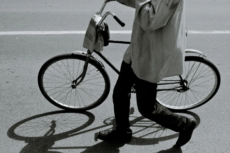 a man standing next to a bike talking on a cell phone, inspired by Ruth Orkin, pexels contest winner, realism, walking, minimal composition, oyasumi punpun, carrying a tray