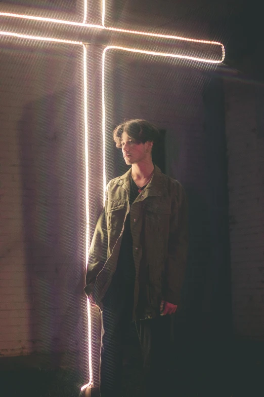 a man standing in front of a lighted cross, an album cover, unsplash, light and space, androgynous male, yukito kishiro, portrait full body, profile image