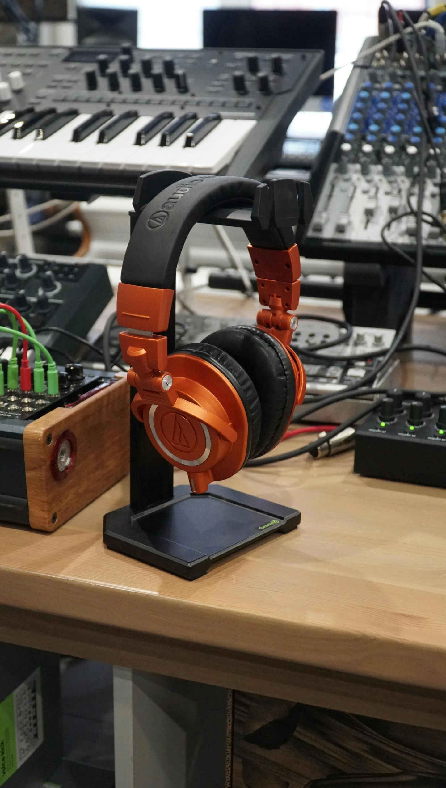 a pair of headphones sitting on top of a wooden table, featured on reddit, private press, oscilloscope, orange metal ears, high quality photo, thumbnail