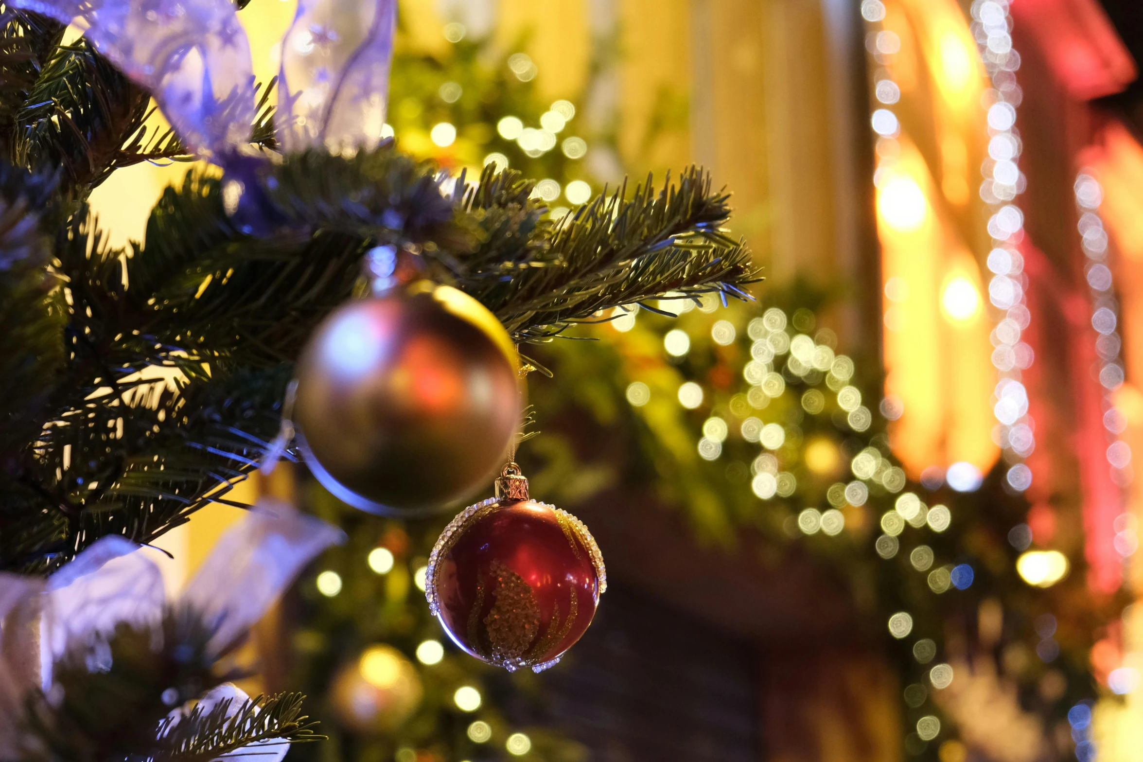 a close up of a christmas tree with ornaments, a portrait, by Dan Content, pexels, hanging out with orbs, cosy enchanted scene, thumbnail, low - angle shot