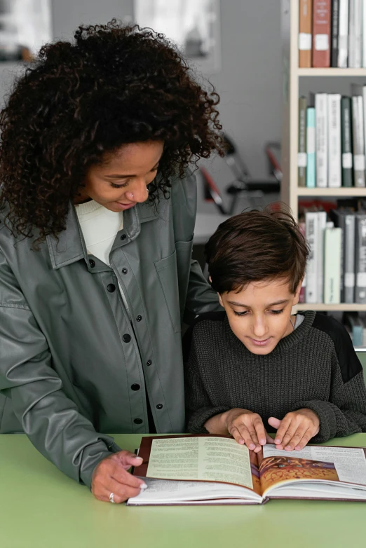 a woman helping a child read a book, pexels contest winner, danube school, future coder looking on, over his shoulder, studio photo, thumbnail