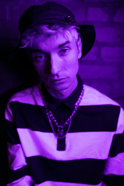 a close up of a person wearing a hat, an album cover, inspired by Cam Sykes, purple scene lighting, ((purple)), young handsome pale roma, dr zeus