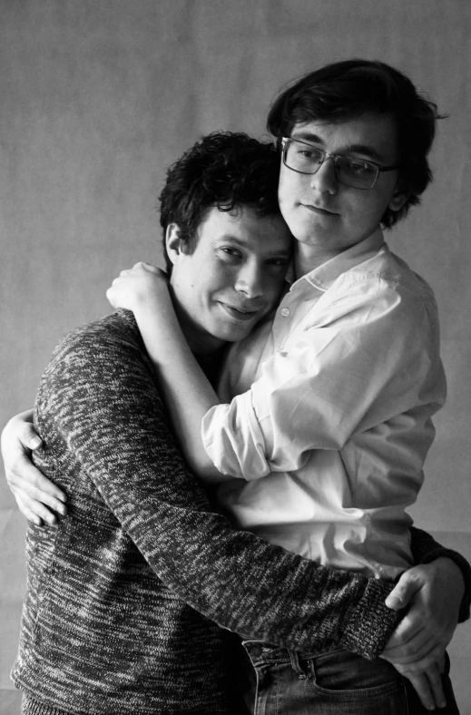 a black and white photo of two people hugging, ben folds portrait, nonbinary model, ffffound, two young men