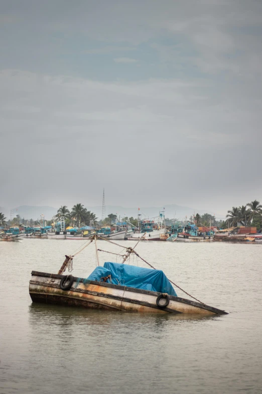 a boat sitting on top of a body of water, inspired by Steve McCurry, happening, fishing village, slide show, grey, uncropped