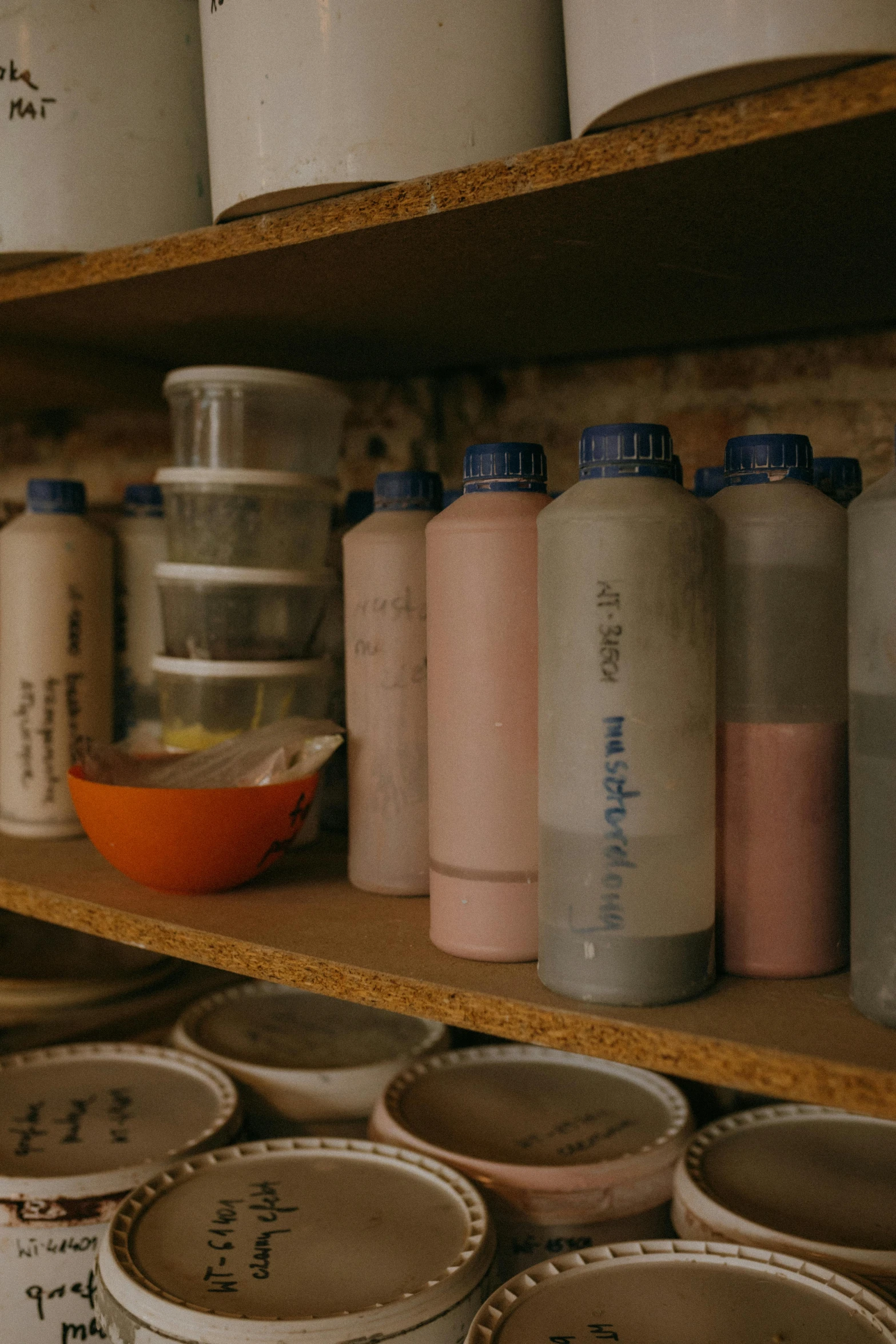 a shelf filled with lots of different types of paint, by Yasushi Sugiyama, process art, terracotta, sake, subtitles, evening light