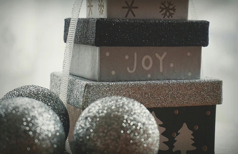 a couple of boxes sitting on top of each other, pexels contest winner, lyco art, glittering silver ornaments, black, joy, grey