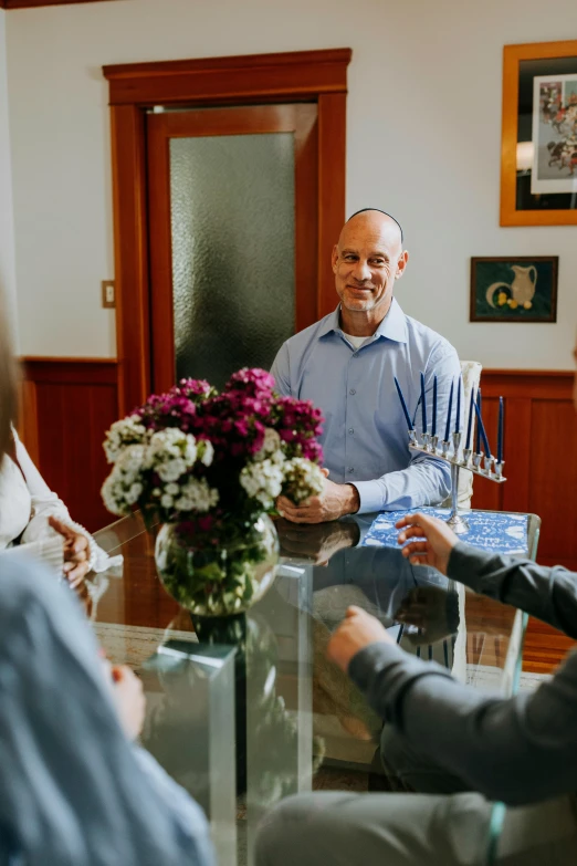 a group of people sitting around a glass table, flowers, benjamin netanyahu, holiday season, on a wooden table