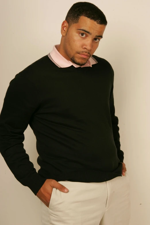 a man in a black sweater and white pants, flickr, gus fring, lean man with light tan skin, pr shoot, display”