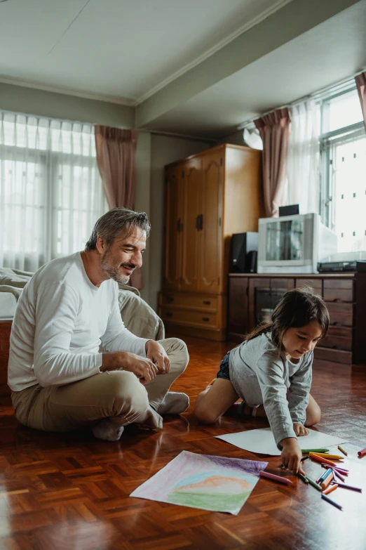 a man and a little girl drawing on the floor, pexels contest winner, cool dad vibes, a still of a happy, profile image, apartment