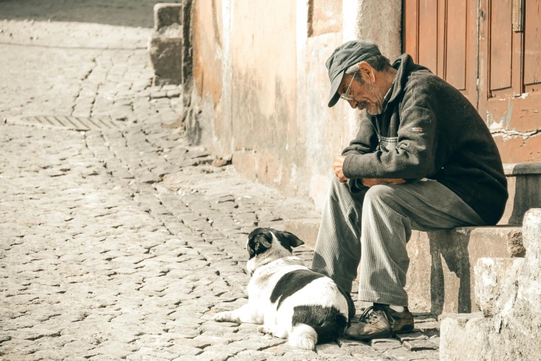 a man sitting on a bench next to a dog, pexels contest winner, realism, in a village street, grumpy [ old ], grandfatherly, resting after a hard mission
