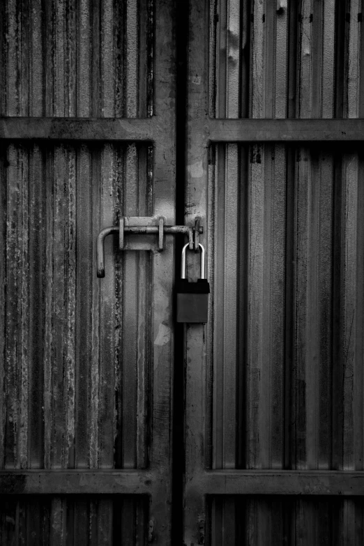 a black and white photo of a lock on a wooden door, a black and white photo, by Pamphilus, unsplash, conceptual art, made of metal, shed, huge gate, scp-049