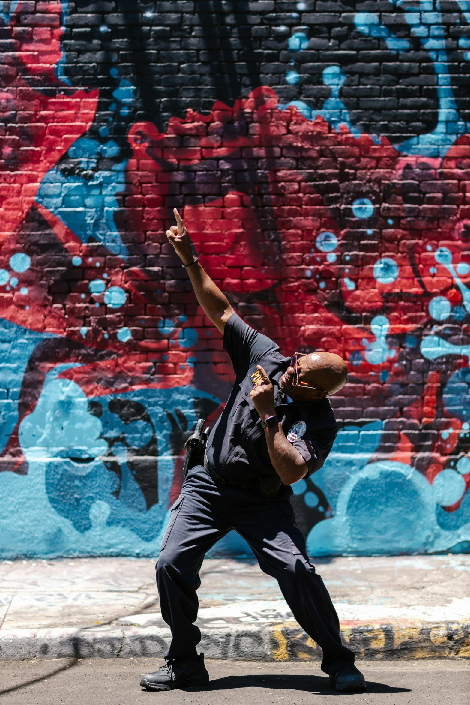 a man on a skateboard in front of a graffiti wall, black arts movement, hybrid of pig and nyc policeman, dynamic dancing pose, promotional image, profile image