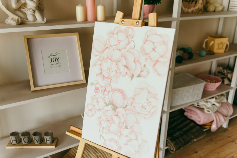 a close up of a easel with a painting on it, inspired by artist, pexels contest winner, pink petals, elegant drawing, 144x144 canvas, indoor picture