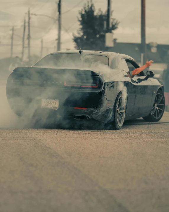 a black car with smoke coming out of it, pexels contest winner, on a street race track, muscle, half turned around, soft color dodge