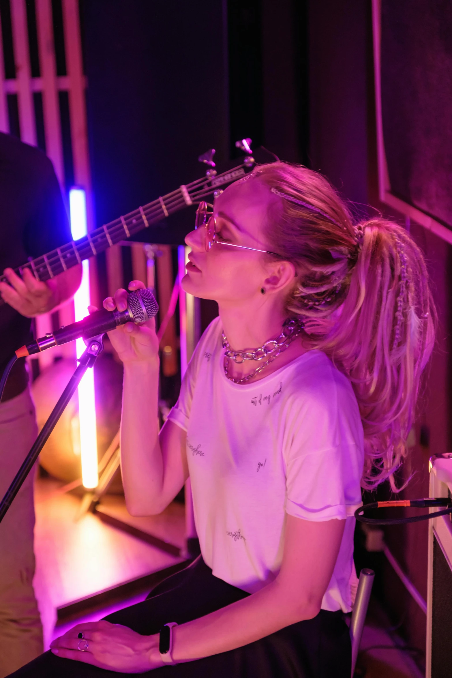 a woman playing a guitar and singing into a microphone, sydney sweeney, blonde hair with a pony tail, brandon woelfel, profile image