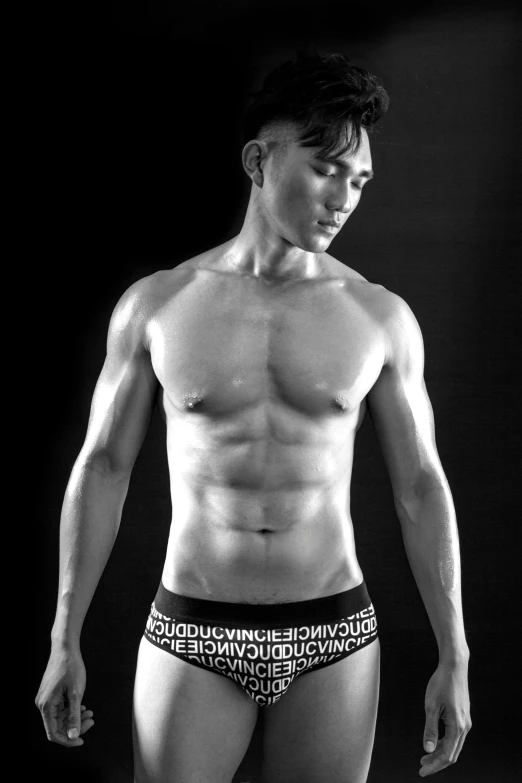 a black and white photo of a man in underwear, inspired by Victor Wang, doug chiang, vascularity, young adult male, standing