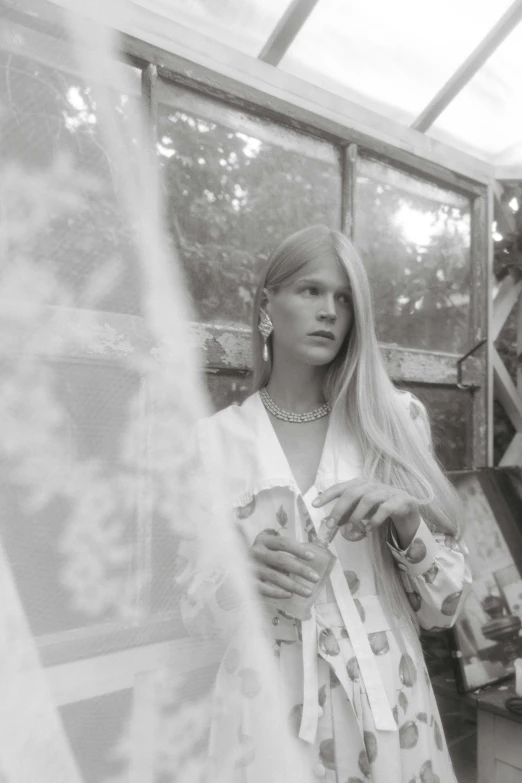 a black and white photo of a woman in a greenhouse, by Eva Frankfurther, renaissance, lara stone, in a white boho style studio, pastel', uploaded